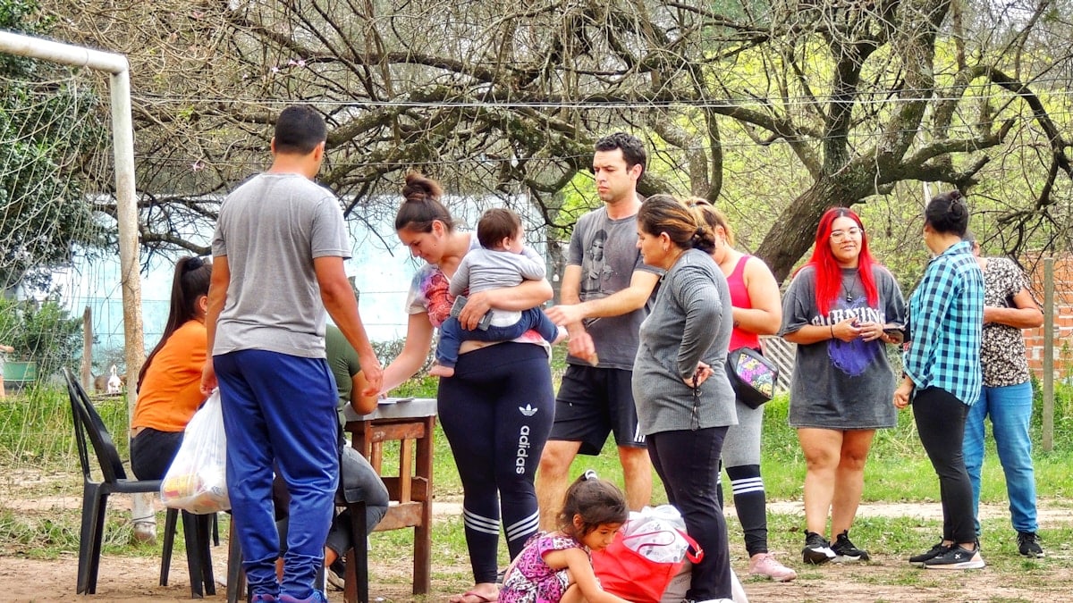 A group of people standing around a soccer goal